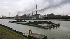 A worker is seen on a pontoon near the former Corus, and current Tata steel factory, background, in IJmuiden, Netherlands, on Tuesday Jan. 30, 2007. 