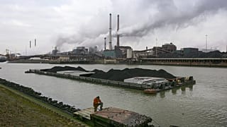 A worker is seen on a pontoon near the former Corus, and current Tata steel factory, background, in IJmuiden, Netherlands, on Tuesday Jan. 30, 2007. 