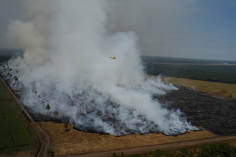 FILE - A wildfire burns near near Ares, France, July 28, 2026. 