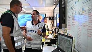 Fire personnel plot out strategies to fight fires in a command center near Claouey, during wildfires in southwestern France, Wednesday, July 29, 2026.
