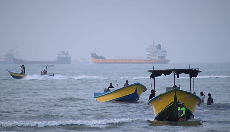 Small boats line the shore as cargo ships and other commercial vessels appear anchored in the Strait of Hormuz off Bandar Abbas, Iran, Monday, July 27, 2026. (Razieh Poudat/IS