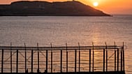 Moroccan men fish on the Moroccan side of the border with Spain, as seen from the district of Benzu in the Spanish enclave of Ceuta, 3 June, 2021.