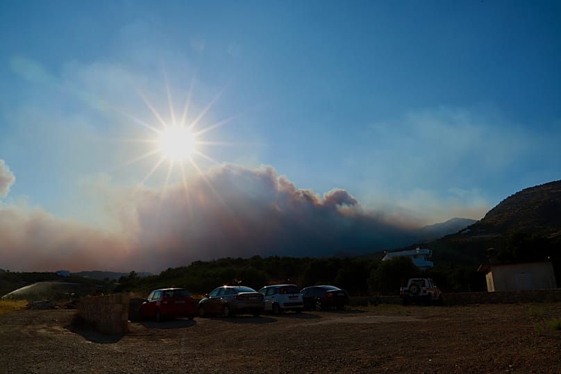 Smoke from a fire burning low vegetation in Krya Vrysi, Rethymno, Crete,