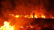 Firefighters use controlled burning to halt a wildfire that continues to spread near Cebreros, Ávila province, Spain, 28 July 2026