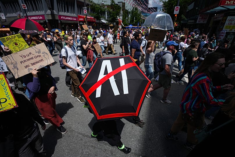 People participate in a march to protest the opening of AI data centers, in Vancouver, British Columbia, Saturday, June 27, 2026