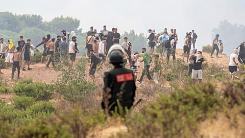 A member of Moroccan security forces stands guard as people attempt to cross from the Moroccan northern town of Fnideq to the Spanish enclave of Ceuta, Friday, July 31, 2026