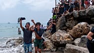 Migrants cross from Morocco into the Spanish enclave of Ceuta on Thursday 30 July 2026.