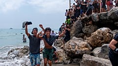 Migrants cross from Morocco into the Spanish enclave of Ceuta on Thursday 30 July 2026.