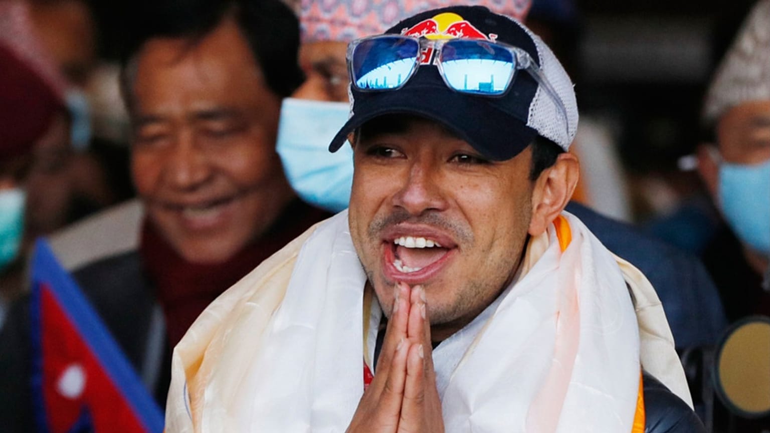 FILE - Nirmal Purja gestures as the team arrives at Tribhuwan International Airport after becoming the first to scale Mount K2 in winter, Kathmandu, Nepal, Jan. 26, 2021