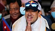FILE - Nirmal Purja gestures as the team arrives at Tribhuwan International Airport after becoming the first to scale Mount K2 in winter, Kathmandu, Nepal, Jan. 26, 2021