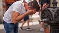 A man cool off in a fountain during a hot and sunny day of summer in Madrid, Spain, July 19, 2023.