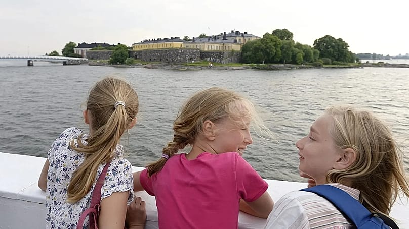 Young girls observe the Suomenlinna Fortress from the ferry that runs between Market Square and the Fortress in Helsinki, Finland, 26 June, 2013.
