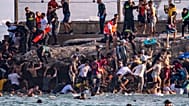 Around 60,000 migrants have crossed into Spain's Ceuta from Morocco in a single day