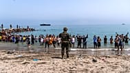 Spanish army soldiers block access to the beach for people crossing from Morocco into the Spanish enclave of Ceuta, Friday, 31 July 2026.