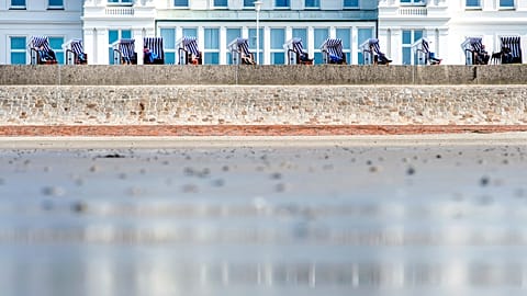 People enjoy the sunny spring weather in beach chairs on the North Sea island of Norderney, northern Germany, on 29 March 2019.