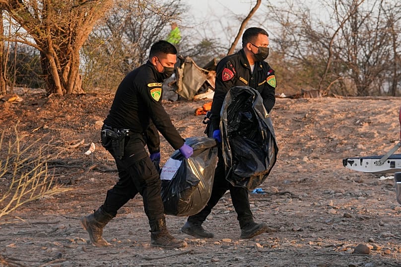 Police officers recover the bodies of the victims who died when a sightseeing flight over the Nazca Lines in Peru crashed. Saturday 1 August 2026
