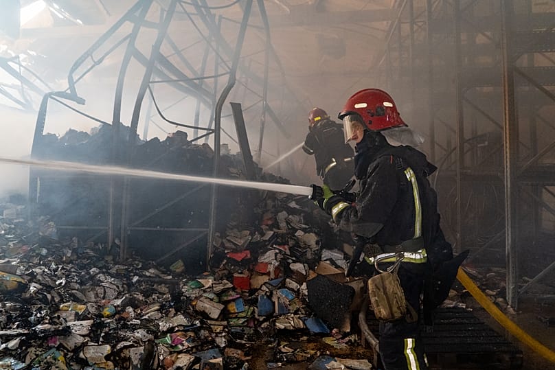 Firefighters put out a fire at a major book warehouse following Russian drone strikes in Kharkiv, Ukraine, Saturday, Aug. 1, 2026.