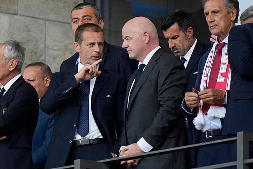 UEFA President Aleksander Ceferin, left, talks to FIFA President Gianni Infantino before a round of sixteen match between Switzerland and Italy at the Euro 2024 tournament.
