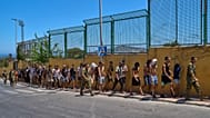 Migrants who crossed into Ceuta are escorted by Spanish soldiers toward the Spanish-Moroccan border for their return to Morocco from the Spanish enclave, Sunday, Aug.2,2026