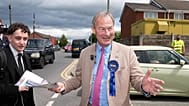 Britain's leader of Restore Britain Rupert Lowe speaks to a members of the public during the by-election in Makerfield, England, Thursday, June 18, 2026.