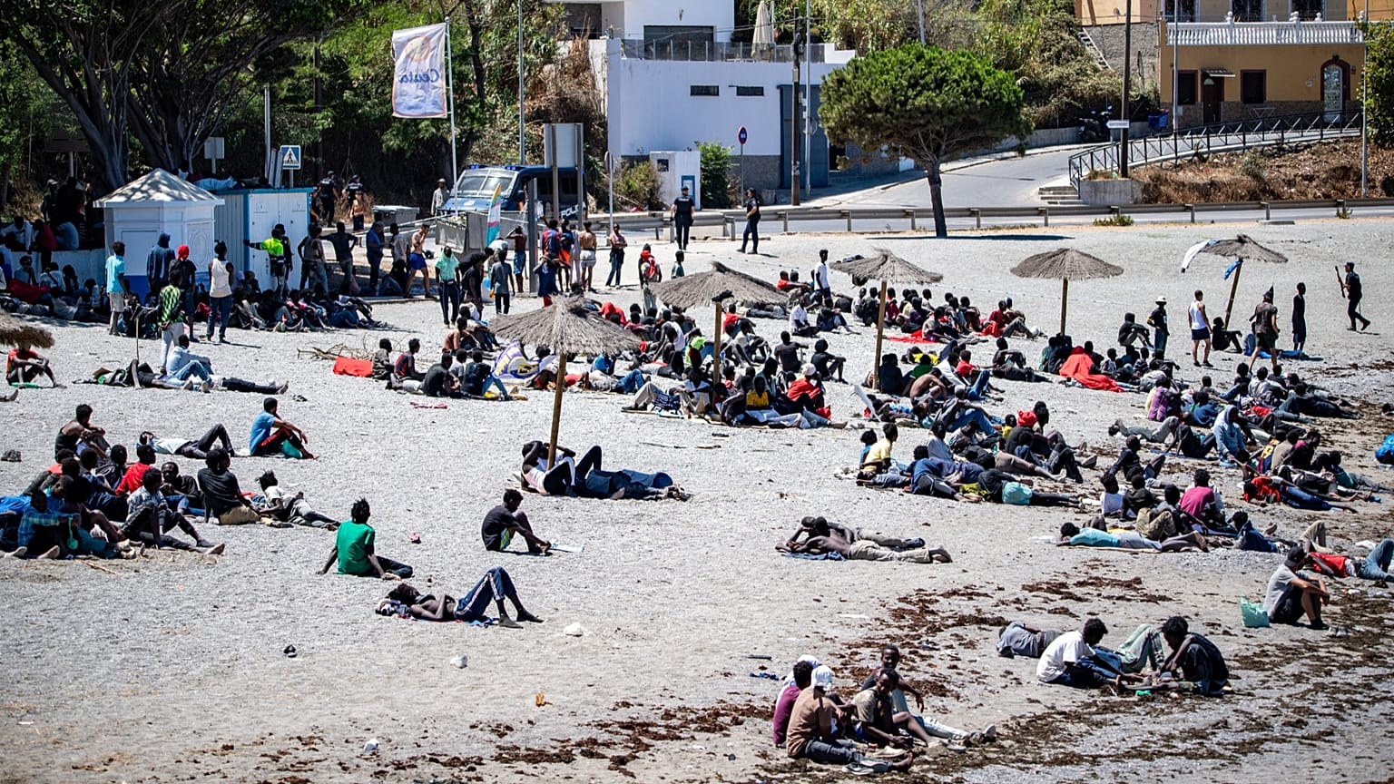 Migrants who crossed into Spain from Morocco gather on a beach in the Spanish enclave of Ceuta, 2 August, 2026