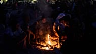 Migrants who crossed into Spain from Morocco gather around a bonfire on a beach in the Spanish enclave of Ceuta, 2 August, 2026
