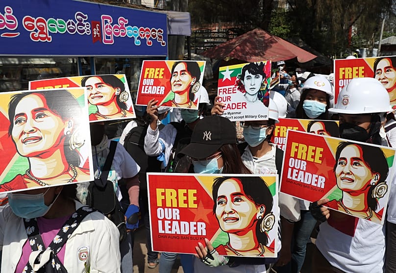 Anti-coup protesters hold images of deposed Myanmar leader Aung San Suu Kyi as they gather in Mandalay, 5 March, 2021 