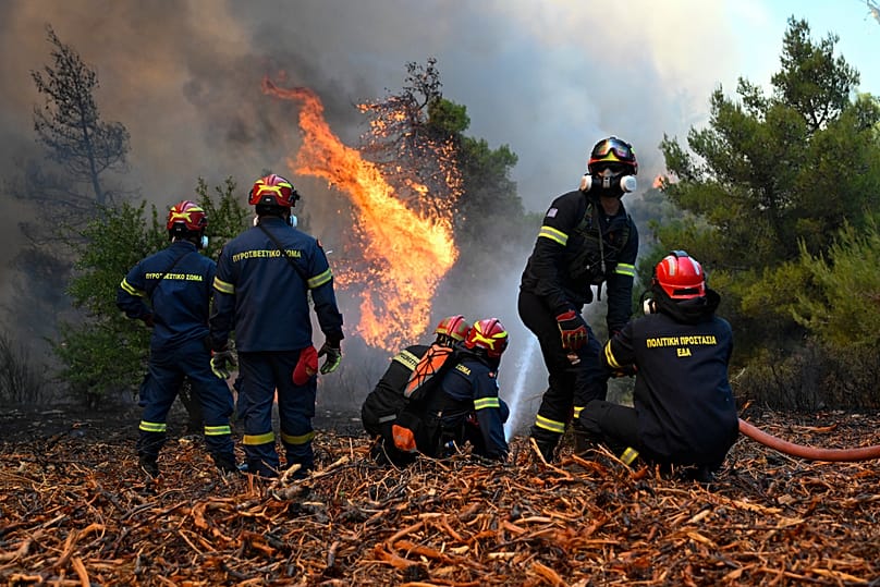 Firefighters operate during a wildfire near Porto Germeno, 2 August, 2026