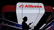 FILE - A visitor walks in front of Alibaba booth during the 3rd China International Supply Chain Expo in Beijing, China. July 18, 2025.