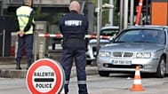  In this Monday, Oct. 31, 2011 file photo, a French gendarme and French custom officer check vehicles, in La Turbie, southeastern France, near the Franco-Italian border
