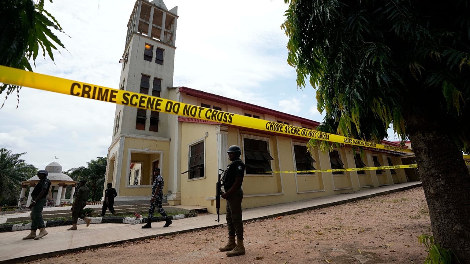 Nigerian police stand guard outside of the St. Francis Catholic church in Owo, 6 June, 2022