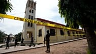 Nigerian police stand guard outside of the St. Francis Catholic church in Owo, 6 June, 2022