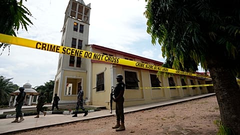 Nigerian police stand guard outside of the St. Francis Catholic church in Owo, 6 June, 2022