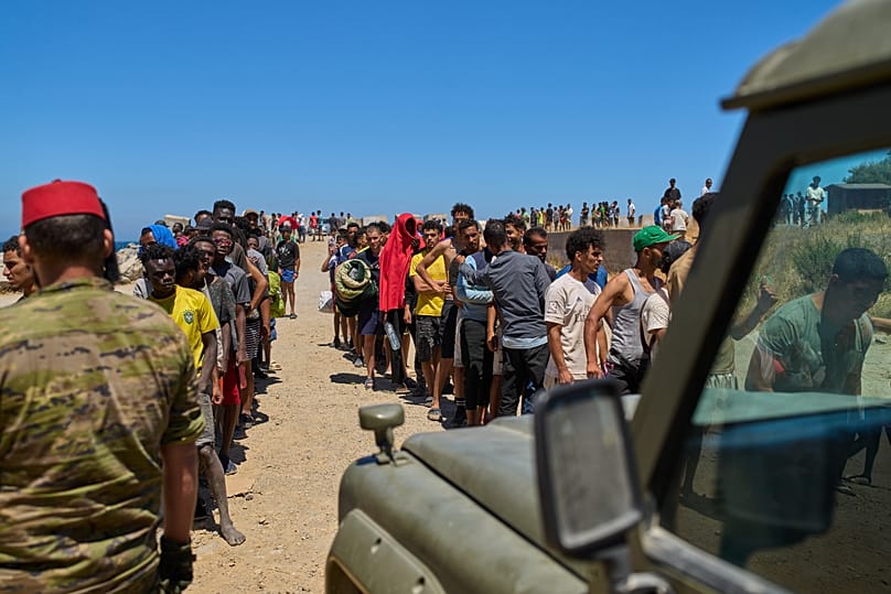 Migrants who crossed into Spain from Morocco line up for water distributed by Spanish soldiers in the Spanish enclave of Ceuta, 2 August, 2026