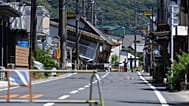 People gather by a damaged house in Hikawa, 31 July, 2026