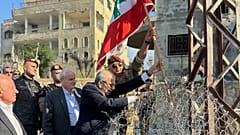 في هذه الصورة التي نشرها المكتب الإعلامي للحكومة اللبنانية، يظهر رئيس الوزراء اللبناني نواف سلام، في الوسط، وهو يرفع العلم اللبناني خلال زيارة إلى قرية زوتر الغربية جنوب لبنان