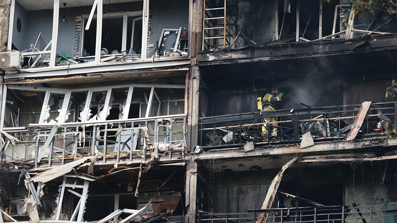Rescuers work at the damaged apartment building following a Russian air guided bomb strike in Zaporizhzhia, 21 July, 2026