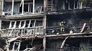 Rescuers work at the damaged apartment building following a Russian air guided bomb strike in Zaporizhzhia, 21 July, 2026