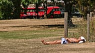 A man sunbathes on dried grass in Green Park in London, as much of the UK is suffering from drought conditions, Monday, Aug. 3, 2026.