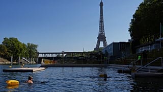 People swim in the Seine river, Monday, Aug. 11, 2025 in Paris. 