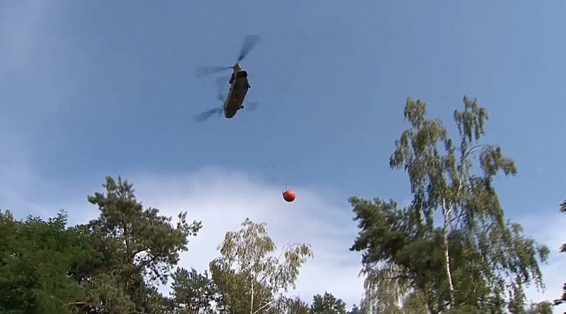 A helicopter drops water on a wildfire in the southern Netherlands, 3 August, 2026