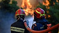 Firefighters operate during a wildfire near Porto Germeno, 2 August, 2026