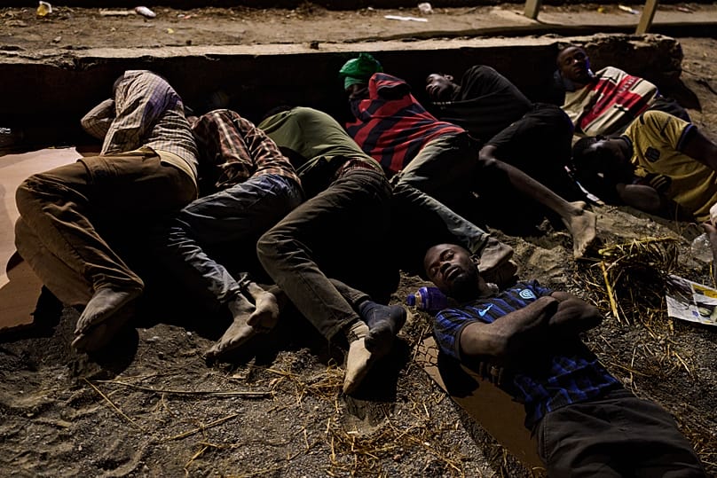 Migrants who crossed into Spain from Morocco sleep on a beach in the Spanish enclave of Ceuta, 3 August, 2026