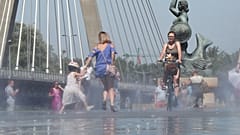 Arquivo. Pessoas refrescam-se junto ao rio Vístula durante uma vaga de calor em Varsóvia, no domingo, 30 de junho de 2019 (AP Photo/Czarek Sokolowski)