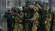 ICE agents armed with less-lethal launchers aim at protesters outside the Delaney Hall detention centre in Newark, 29 May, 2026 