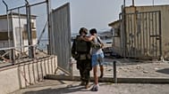 An injured migrant who crossed into Spain returns to Morocco with the assistance of a Spanish soldier from the Spanish enclave of Ceuta, 1 August, 2026. 