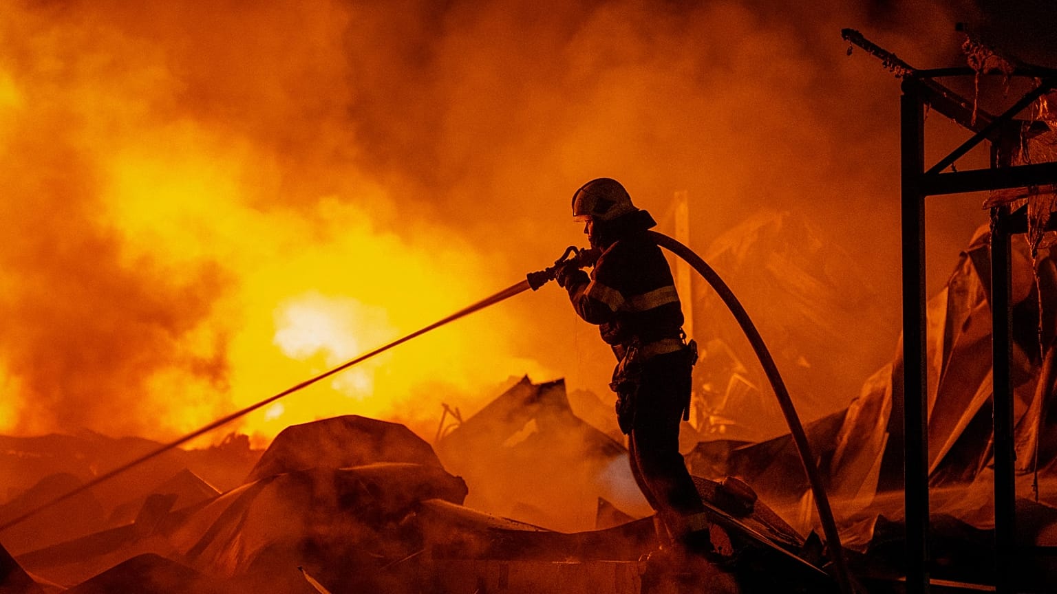 Firefighters put out a fire after Russian missiles hit a warehouse in Kyiv, 5 August, 2026