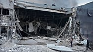 Police officers examine the damaged Nova Poshta postal warehouse after Russian missiles strikes in Kyiv, 5 August, 2026