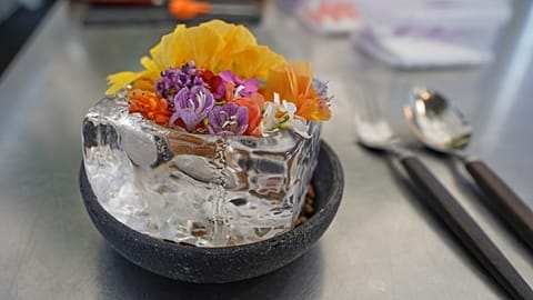 A new berry gazpacho dish topped with flower petals presented in fine -dining restaurant Noma's test kitchen in Copenhagen, Denmark Tuesday, July 28, 2026.