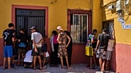 Migrantes, algunos de ellos menores no acompañados, que cruzaron de Marruecos a España, anotan sus datos de contacto para entregárselos a una asociación de vecinos